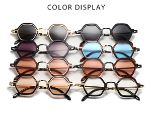 Multiple vintage hexagonal sunglasses in various colors with metallic frames and punk style