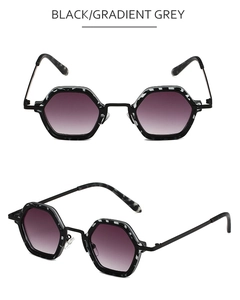 Detail of hexagonal sunglasses featuring ink-pattern frames and gradient grey lenses