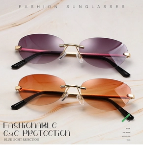 Flat lay of vintage rimless sunglasses with gold frames and gradient tinted lenses