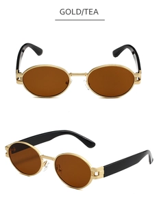 Détail macro de lunettes de soleil ovales avec monture dorée et verres teintés thé
