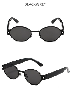 Vue détaillée des lunettes de soleil ovales noires avec verres gris et branches larges