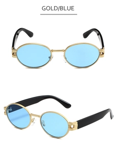 Détail de lunettes de soleil ovales dorées avec verres bleus et branches noires