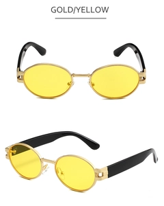 Détail de lunettes de soleil ovales avec monture dorée et verres teintés jaunes
