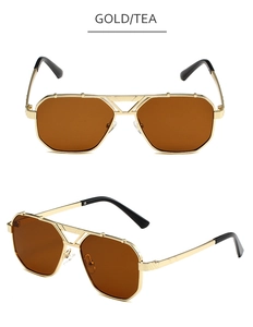 Detail of gold aviator sunglasses with tea lenses and double bridge metal frame