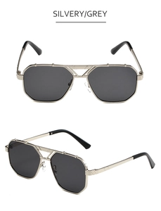 Detail of silver double-bridge aviator sunglasses with classic grey lenses and metal frame