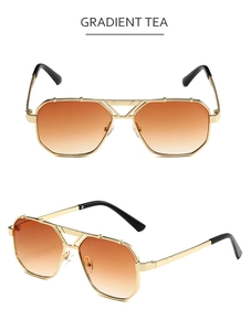 Detail view of gold double-bridge aviator sunglasses with gradient tea lenses
