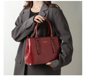 Detailed view of burgundy glossy leather tote bag with Fashion & Bags logo engraving