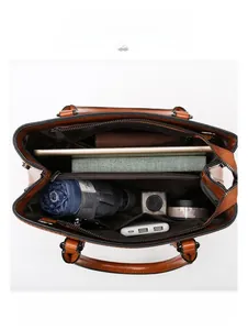 Internal view of brown vintage tote bag showing spacious multi-layer storage for iPad