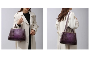 Detail view of purple crocodile texture handbag with gold handles and shoulder strap