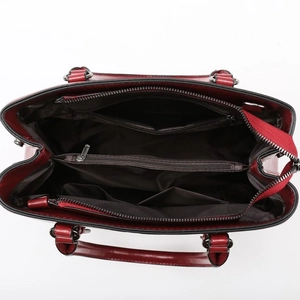 Deep red tote bag interior with multi-compartment layout and dark brown fabric lining