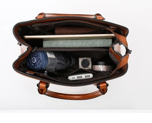 Internal view of brown leather tote bag with multiple compartments and high capacity