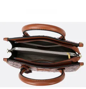 Internal display of the brown crocodile pattern tote showing the three-compartment design