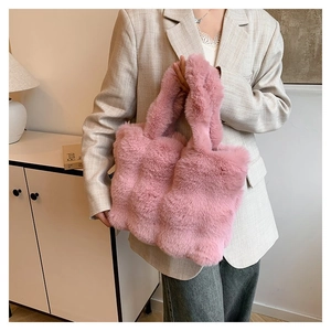 Detail of pink faux fur tote bag showing plush texture and chunky winter handle