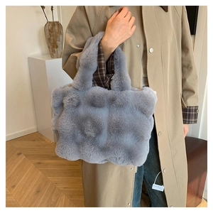 Close-up of blue-grey plush handbag with unique bobble texture and soft faux fur material