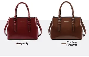Detail view of burgundy and coffee glossy leather tote bags with gold fashion logo