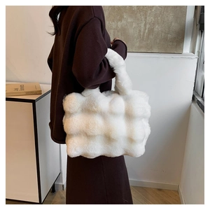 Winter plush tote bag with checkered faux fur texture carried by a model in a knit dress