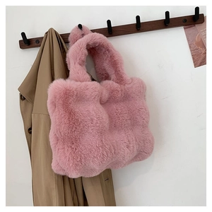 Pink plush handbag detail featuring soft faux fur texture and a stylish curved handle