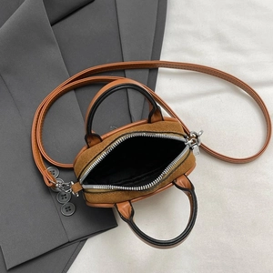 Brown minimalist tote bag with stitching detail and crossbody strap shown from a 45-degree angle