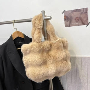 Detail of soft plush tote bag in light camel faux fur with fluffy wide handle