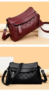Detail of lychee pattern leather bags with embossed checkered patterns and straps
