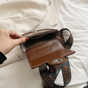 Brown vintage leather shoulder bag with wide geometric strap and interior compartments