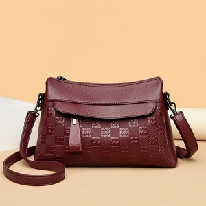 Chic burgundy quilted leather crossbody bag with houndstooth patterns and adjustable strap