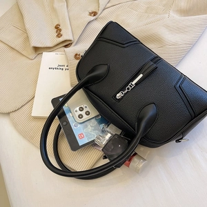 Top view of black lychee grain handbag with V-stitch design and metal D-pendant