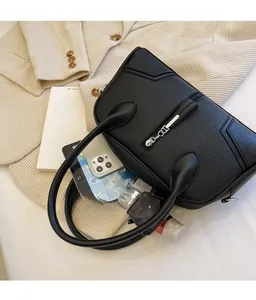 Top-down view of black lychee grain leather bag showing large capacity for essentials