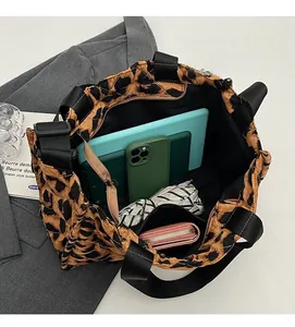 Spacious interior of leopard print quilted tote bag holding tablet and daily essentials