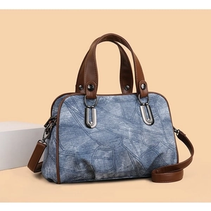 Retro denim crossbody bag with brown leather trim and silver U-shaped metal buckle