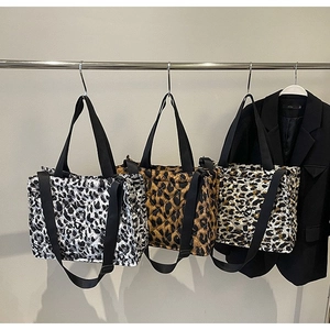 Three quilted leopard print tote bags in brown and beige with black shoulder straps