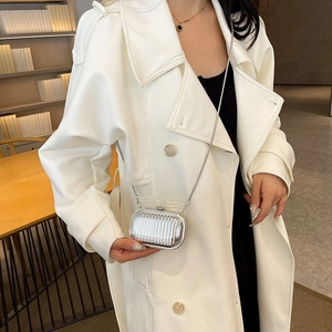 Silver metallic pleated clutch with elegant chain strap shown on a model side view