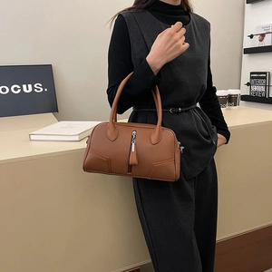 Brown lychee leather Boston bag featuring detailed stitching and dual handles