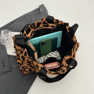 Internal view of leopard print quilted tote bag showing large capacity and multi-pockets