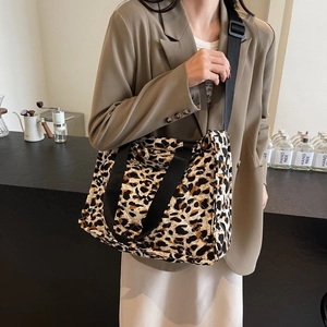 Chic leopard print quilted tote bag worn by a model in a stylish indoor setting