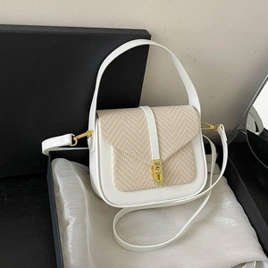 Minimalist white leather and woven fabric crossbody handbag with gold buckle in a gift box