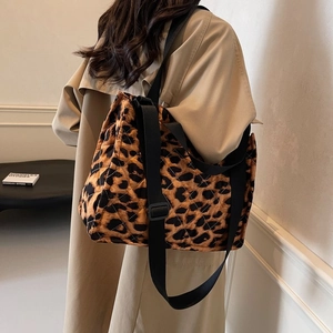Detail of leopard print quilted tote bag with wide adjustable black nylon shoulder strap