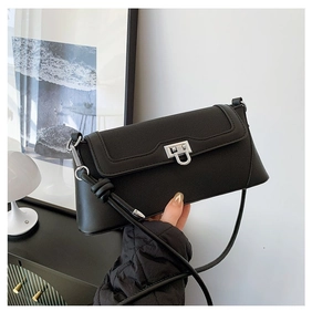Detail of black underarm bag featuring silver U-shaped metal buckle and knot strap design
