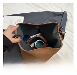 Top view of brown matte bucket bag interior with removable pouch and magnetic closure