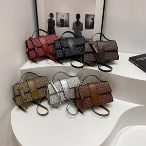 Detailed view of woven leather texture and metal buckle on stylish crossbody bags