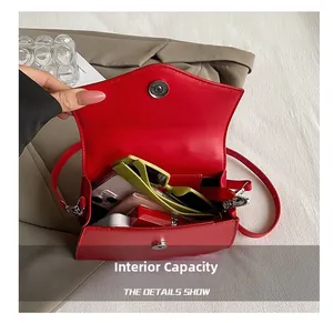 Interior view of red crossbody bag showing storage for phone, wallet and sunglasses