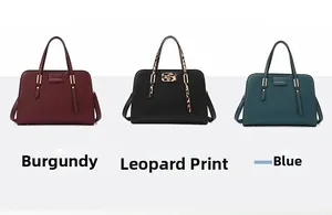 Detail view of small square crossbody bags in wine red, blue, and leopard print leather