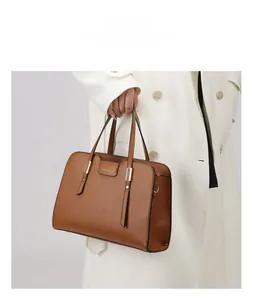 Caramel lychee grain leather handbag detail featuring gold hardware and fashion embossing