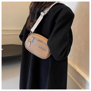 Detail of tan pebble leather crossbody bag with ethnic patterned wide shoulder strap