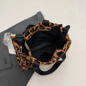 Chic quilted leopard print tote bag with spacious interior and black shoulder strap