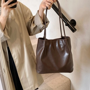 Deep brown tote bag with glossy synthetic leather and pleated opening detail on shoulder