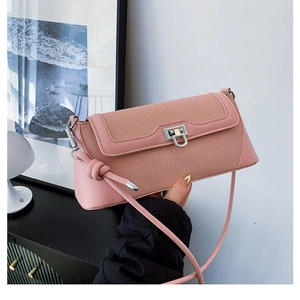 Elegant pink patchwork crossbody bag with textured fabric flap and silver U-shaped lock