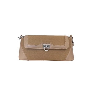 Retro canvas and brown leather crossbody bag with silver square lock on white background