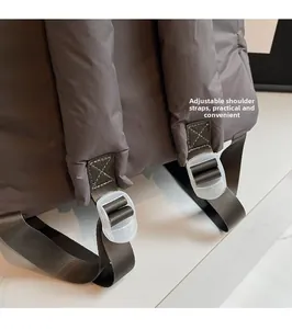 Detail of adjustable nylon shoulder strap with plastic buckle on a quilted backpack