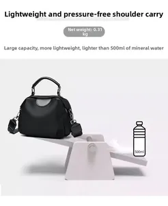 Black nylon shoulder bag weighing only 0.31kg shown light as a feather on a scale